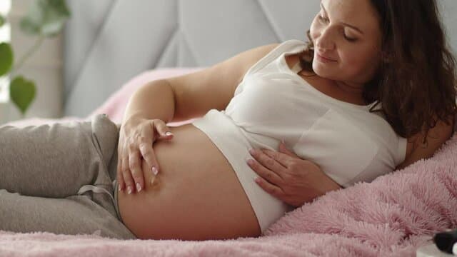 Pregnant woman resting comfortably at home